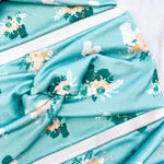 Adult women's light blue headband with yellow and white flowers surrounding white and black fluffy Silkie chickens