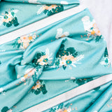 Adult women's light blue headband with yellow and white flowers surrounding white and black fluffy Silkie chickens