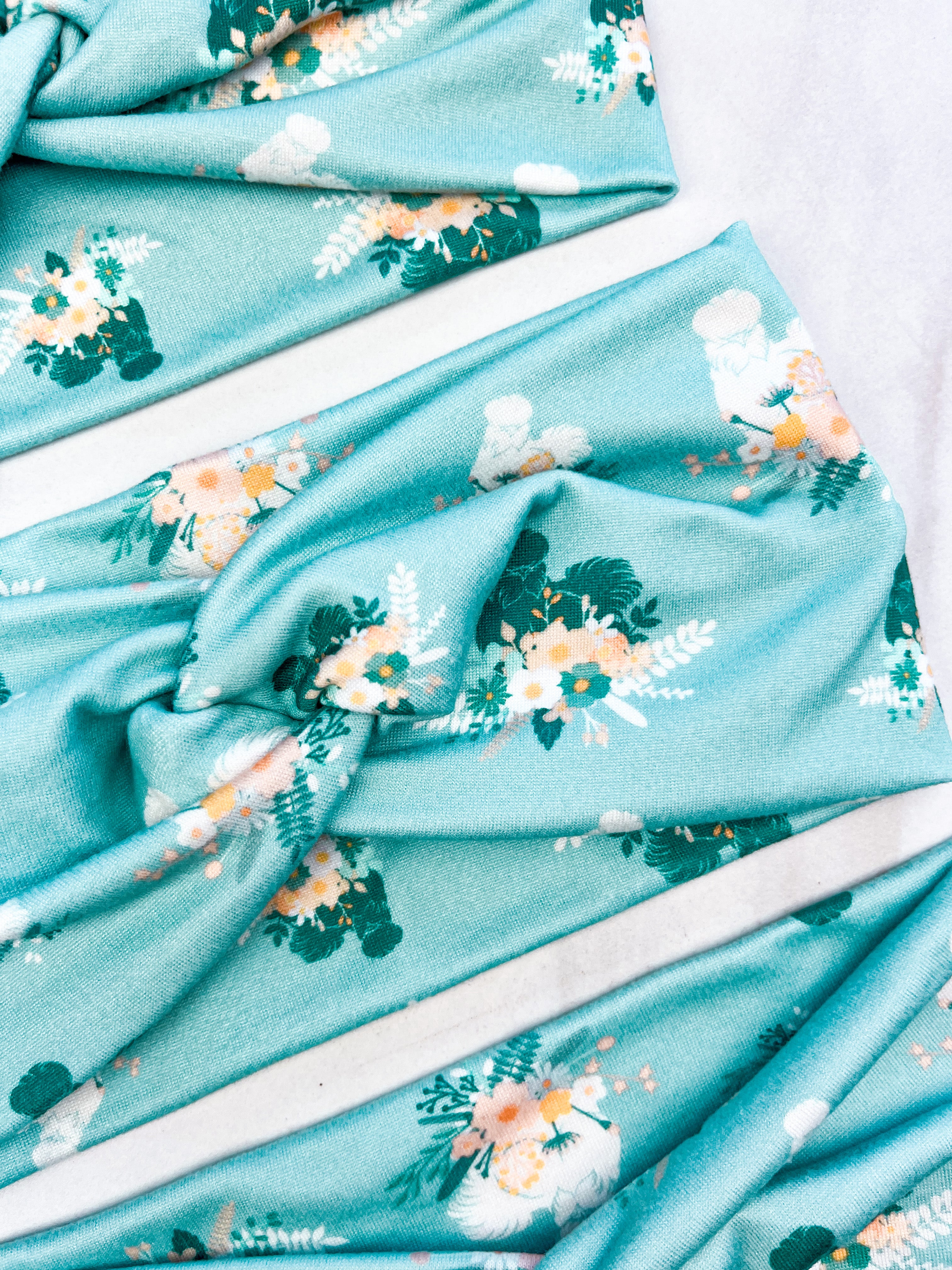 Adult women's light blue headband with yellow and white flowers surrounding white and black fluffy Silkie chickens