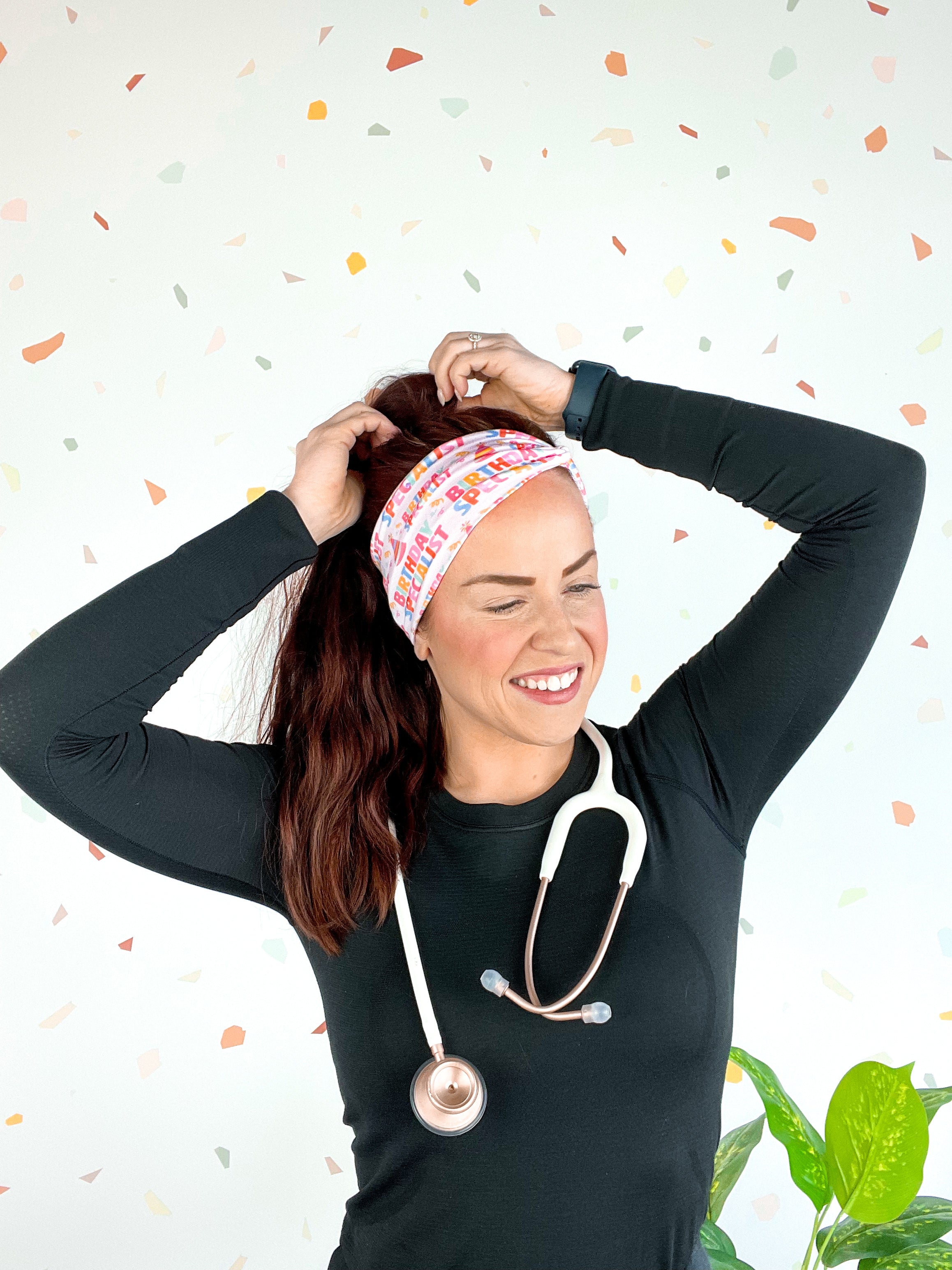 Birthday Specialist Lilac Market Headband worn by a woman with a stethoscope, showcasing a versatile 3-in-1 twist style for confidence and function.