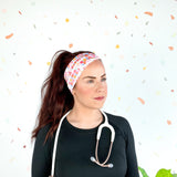 Birthday Specialist Lilac Market Headband worn by a woman with a stethoscope, showcasing a versatile 3-in-1 twist style for confidence and function.