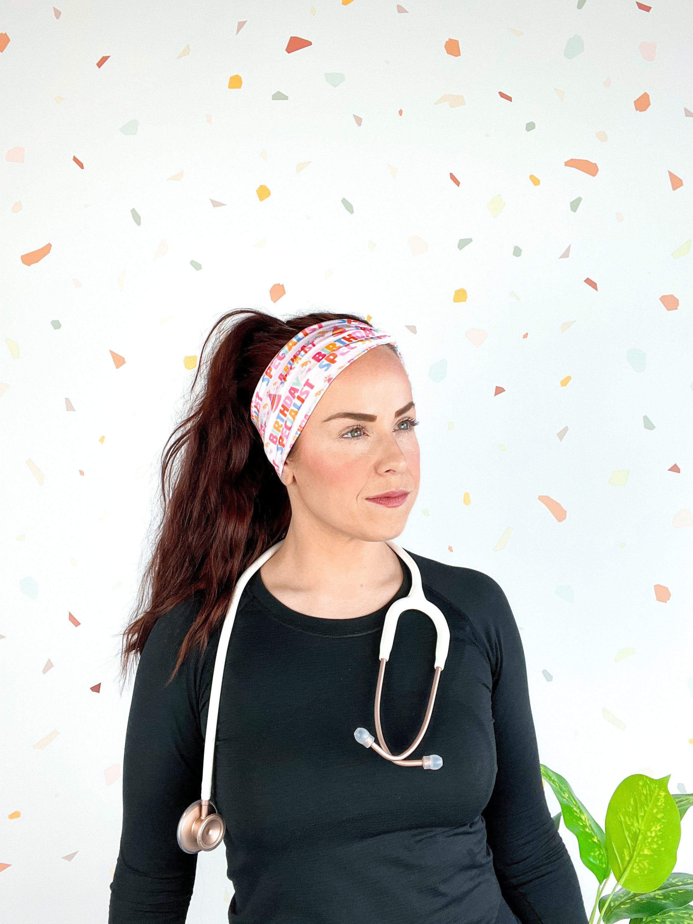 Birthday Specialist Lilac Market Headband worn by a woman with a stethoscope, showcasing a versatile 3-in-1 twist style for confidence and function.