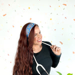 Stork Squad blue headband worn by woman with stethoscope and long hair.