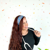 Stork Squad blue headband worn by woman with stethoscope and long hair.