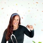 Stork Squad blue headband worn by woman with stethoscope and long hair.