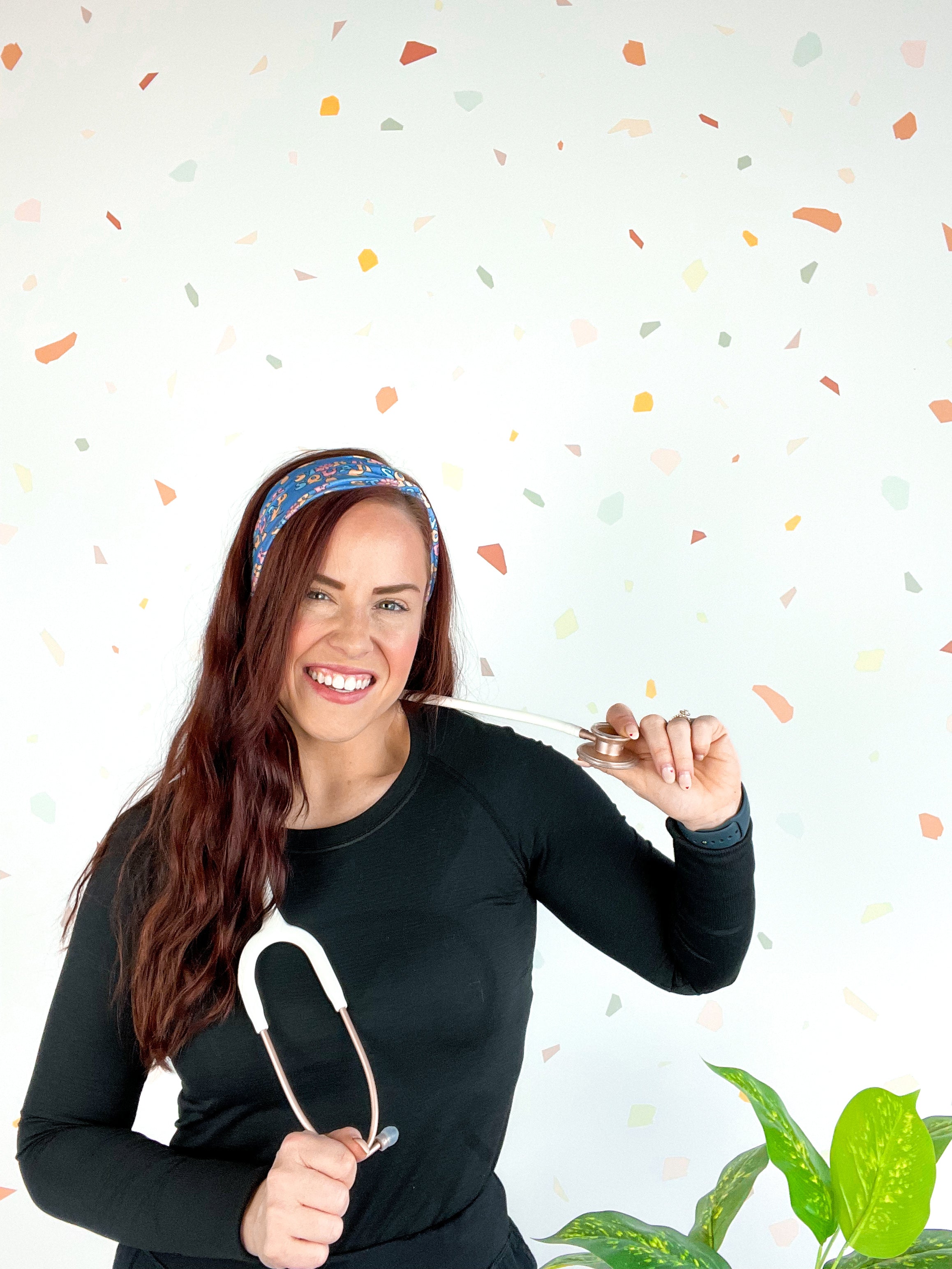 Stork Squad blue headband worn by woman with stethoscope and long hair.