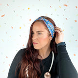 Stork Squad blue headband worn by woman with stethoscope and long hair.
