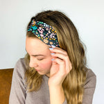 Adult women's black headband with mustard and pink flowers and green and teal greenery