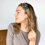 Adult women's black headband with mustard and pink flowers and green and teal greenery
