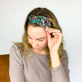Adult women's black headband with mustard and pink flowers and green and teal greenery