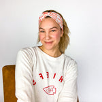 Adult women's grey headband with red and yellow drawings of Travis Kelce, his jersey number, KC Chiefs and hand-drawn hearts that says 'Go Taylor Swift's Boyfriend'