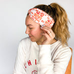 Adult women's grey headband with red and yellow drawings of Travis Kelce, his jersey number, KC Chiefs and hand-drawn hearts that says 'Go Taylor Swift's Boyfriend'