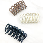 A group of loopy hair clips, including the Take It Easy Lilac Clip, perfect for all hair types and textures. 4 inches long. Matte material. Hinge closure. Hair-out-of-face approved.