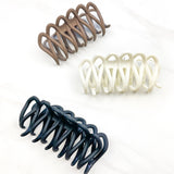 A group of loopy hair clips, including the Take It Easy Lilac Clip, perfect for all hair types and textures. 4 inches long. Matte material. Hinge closure. Hair-out-of-face approved.