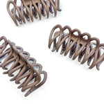 A group of loopy brown hair clips, including the Take It Easy Lilac Clip, perfect for all hair types and textures. 4 inches long. Matte material. Hinge closure. Hair-out-of-face approved.