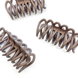 A group of loopy brown hair clips, including the Take It Easy Lilac Clip, perfect for all hair types and textures. 4 inches long. Matte material. Hinge closure. Hair-out-of-face approved.