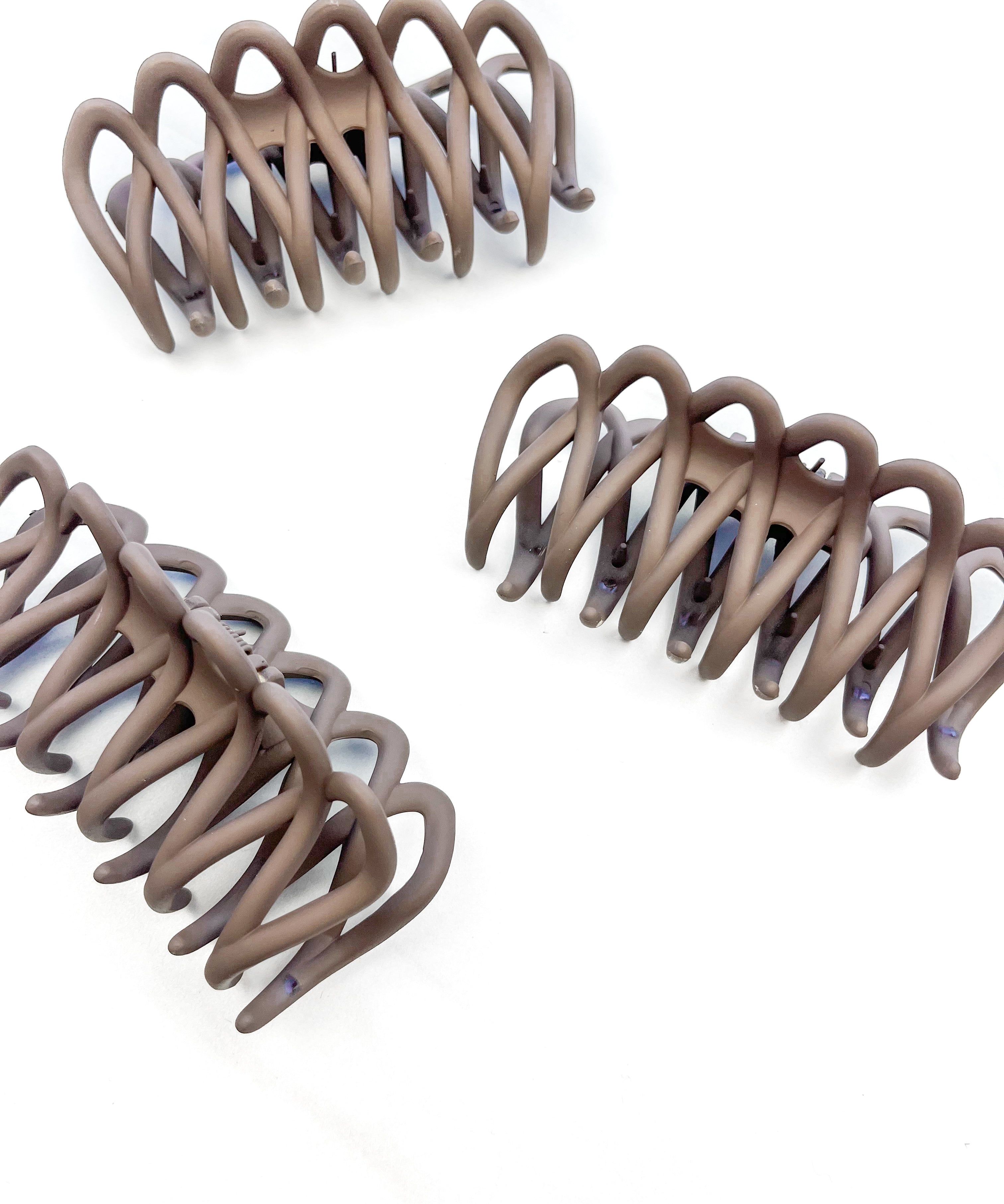 A group of loopy brown hair clips, including the Take It Easy Lilac Clip, perfect for all hair types and textures. 4 inches long. Matte material. Hinge closure. Hair-out-of-face approved.