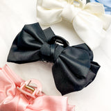 Four of the Classy Chic Lilac Clips, a perfect claw clip for all hair types and textures, made of white, black, pink or blue silky satin material with a hinge closure.