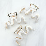 Effortless Lilac Clip, a group of hair clips with white marble and gold trim, perfect for all hair types and textures.