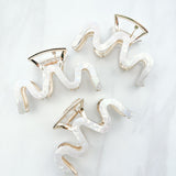 Effortless Lilac Clip, a group of hair clips with white marble and gold trim, perfect for all hair types and textures.