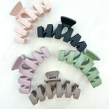 Hair claw clip in sage, mocha, tan, mauve or black in zig zag shape.