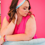 Adult women's wavy striped gradient headband from hot pink, orange, light blue and blue