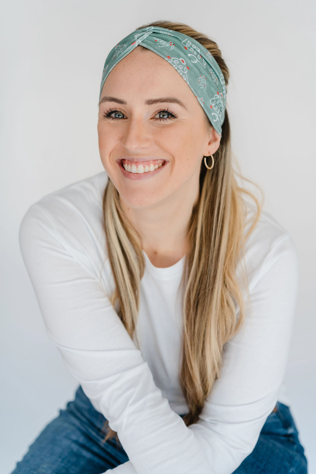 Adult women's sage headband with slightly lighter sage spots and white stethoscopes in the shape of Christmas trees