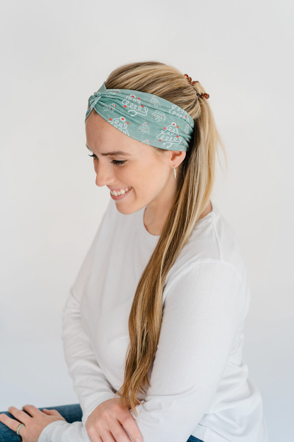 Adult women's sage headband with slightly lighter sage spots and white stethoscopes in the shape of Christmas trees