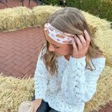 Adult women's blush headband with slices of pumpkin pie and whipped cream and yellow and brown stars