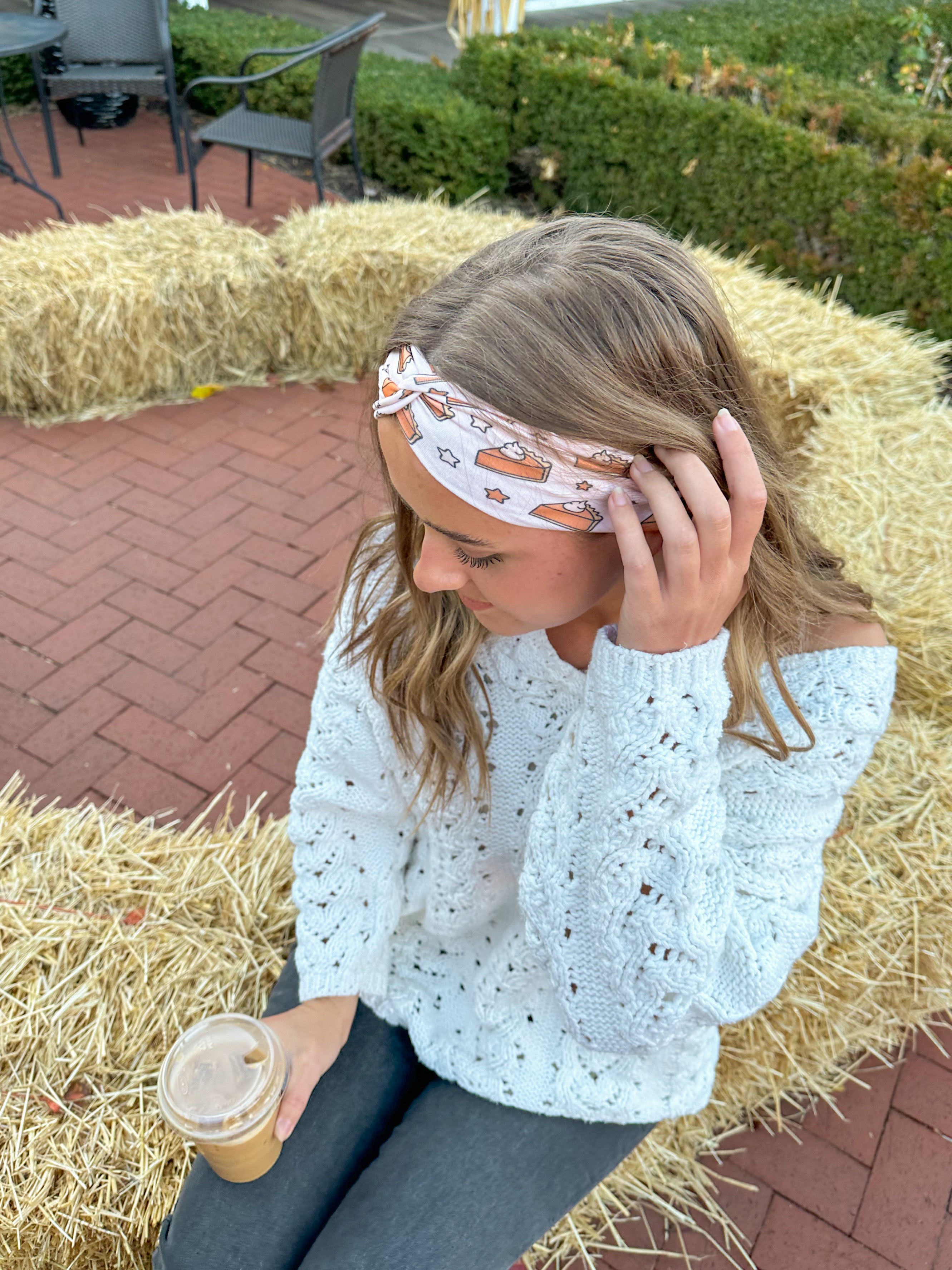 Adult women's blush headband with slices of pumpkin pie and whipped cream and yellow and brown stars