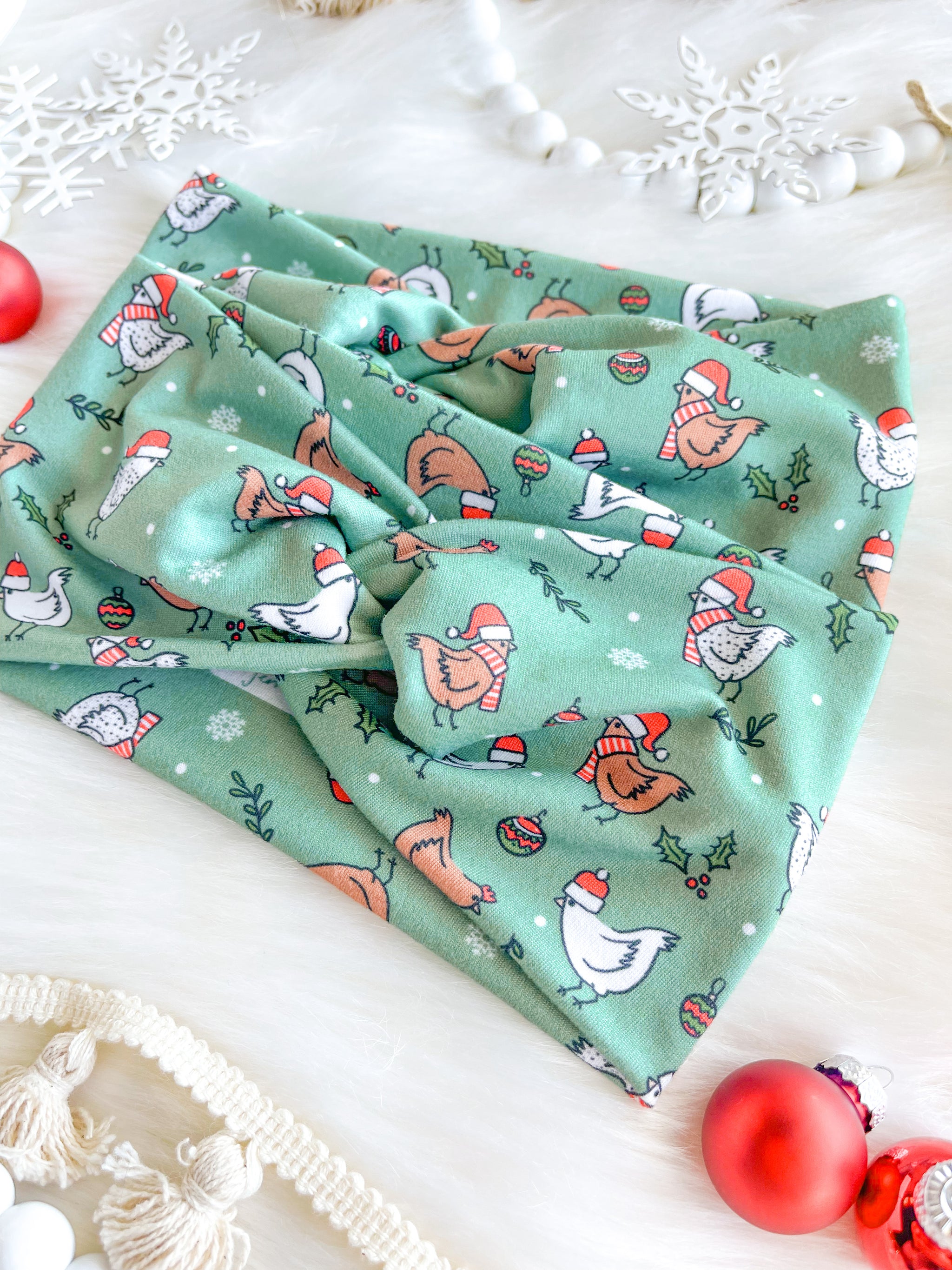 Adult women's light sage headband with brown and white cartoon chickens wearing red Santa hats and scarves, mistletoe and snowflakes