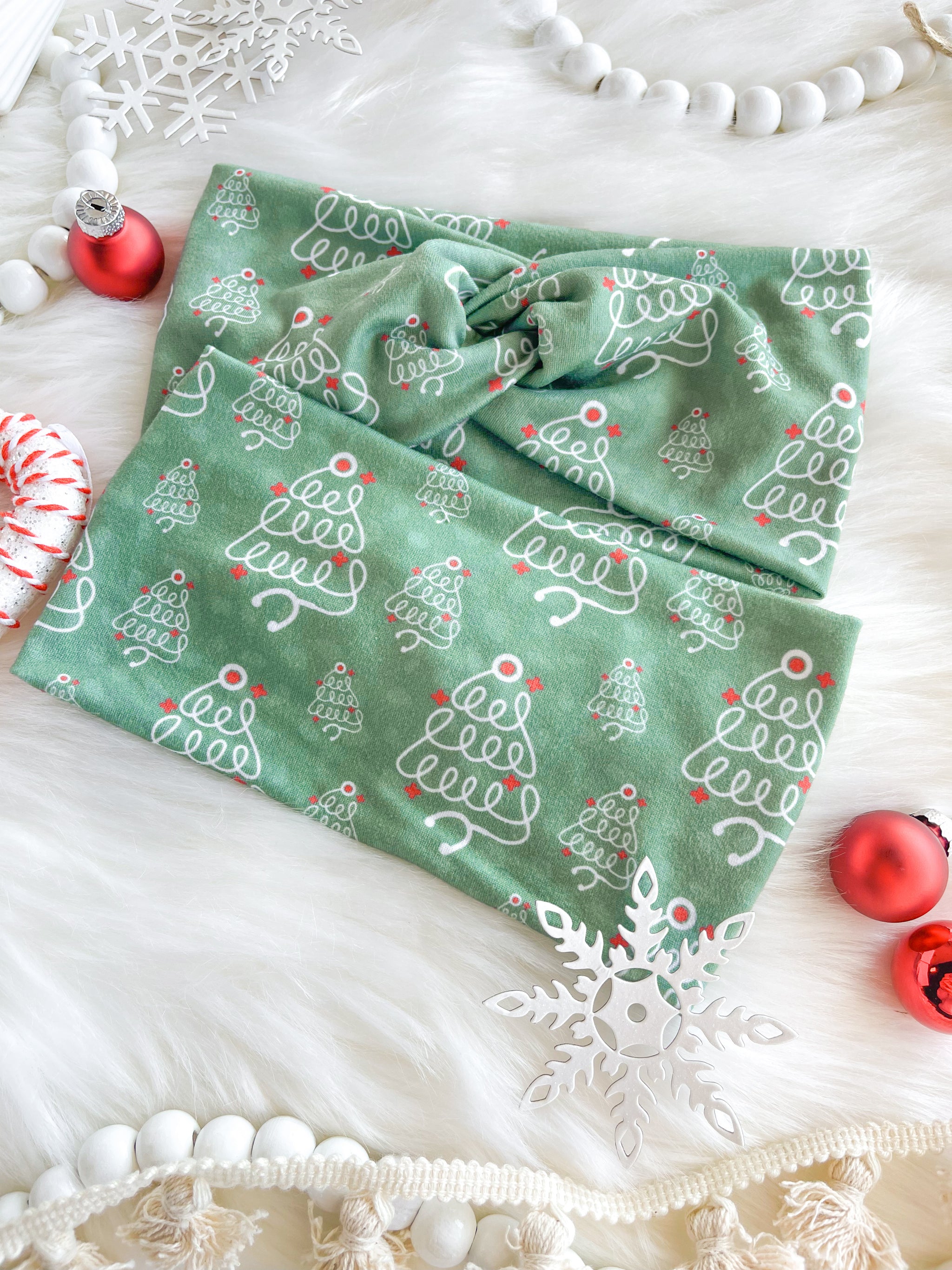 Adult women's sage headband with slightly lighter sage spots and white stethoscopes in the shape of Christmas trees