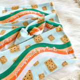 Adult women's light blue headband with a wavy rainbow of teal, orange and coral and unfrosted pop-tarts with the words "you unfrosted pop-tart" in cursive