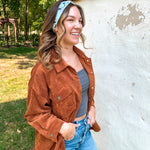 Woman smiling, wearing the Purranormal Activity headband from Lilac Market, featuring a versatile 3-in-1 twist style and buttery-soft, ultra-stretchy poly-knit blend.