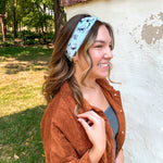 Woman smiling, wearing the Purranormal Activity headband from Lilac Market, featuring a versatile 3-in-1 twist style and buttery-soft, ultra-stretchy poly-knit blend.