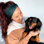 Adult women's black headband with white drawn outline of a playful Dachshund dog
