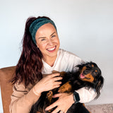 Adult women's black headband with white drawn outline of a playful Dachshund dog