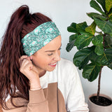 Adult women's dark green headband with teal elephants and greenery, pink tusks and legs and flowers
