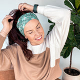 Adult women's dark green headband with teal elephants and greenery, pink tusks and legs and flowers