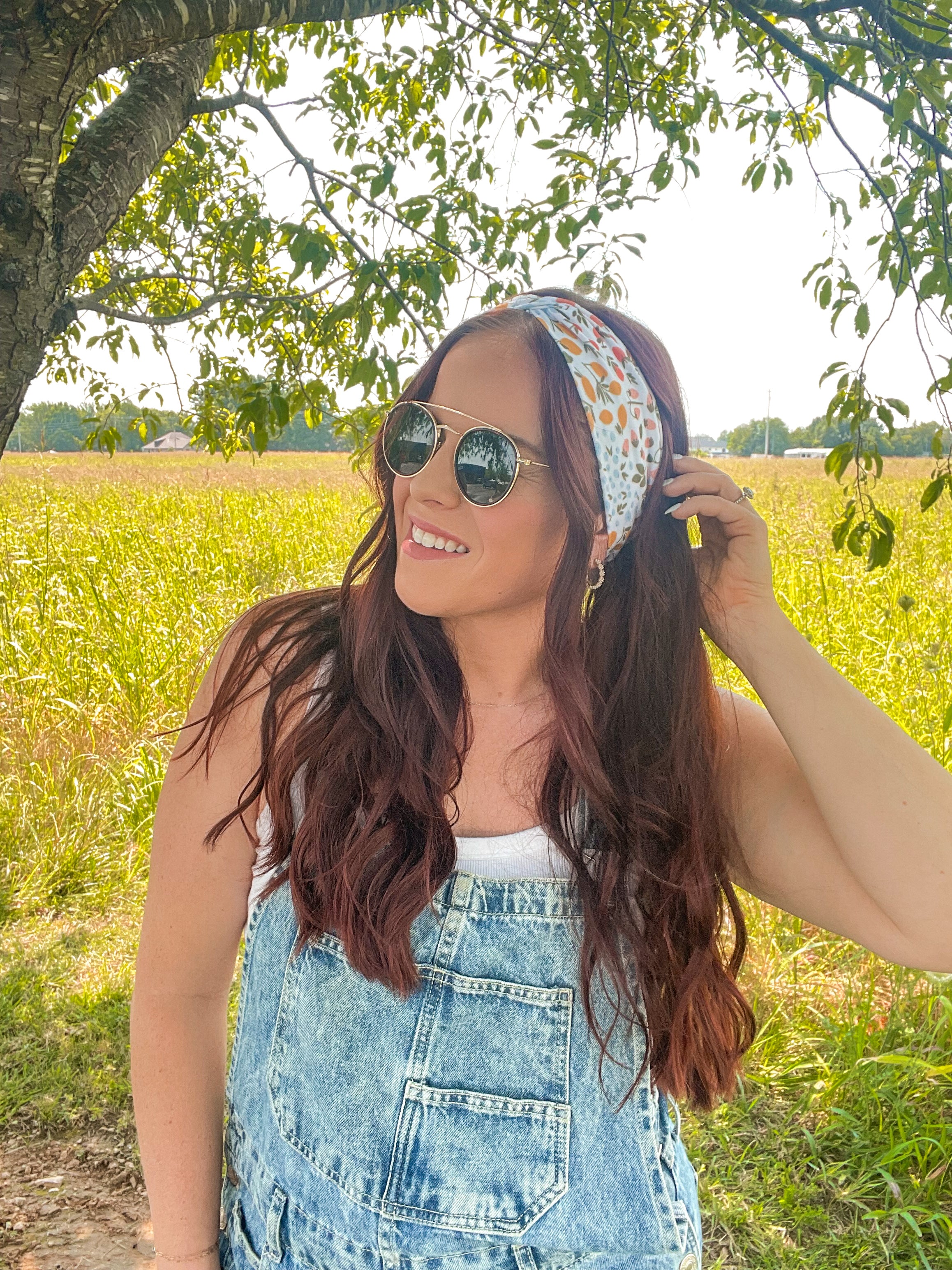 Woman shows off her style in the Fresh From The Market headband, perfect for a long shift or fun play day.