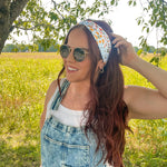 Woman shows off her style in the Fresh From The Market headband, perfect for a long shift or fun play day.