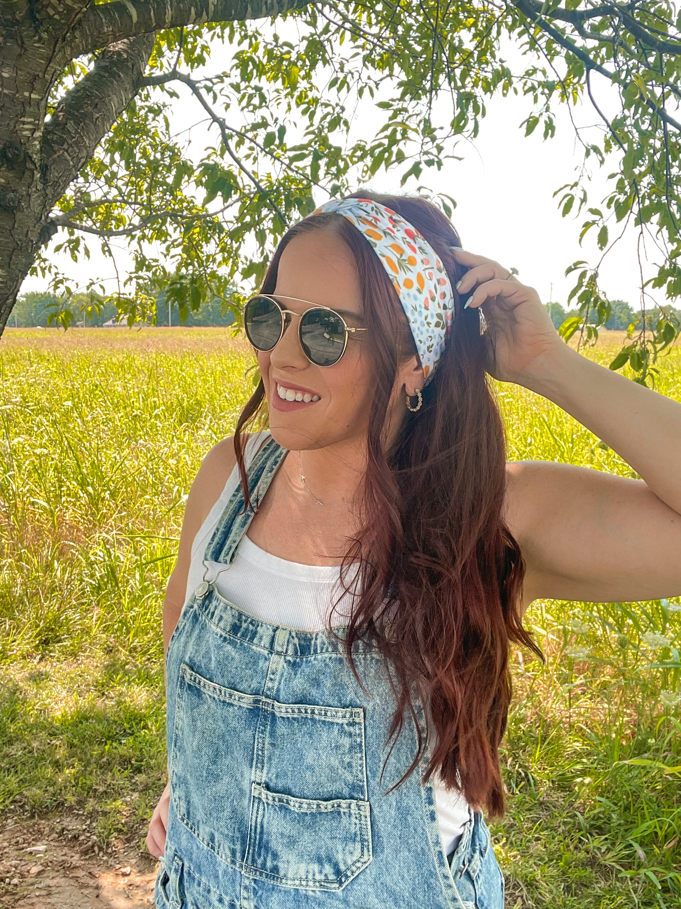 Woman shows off her style in the Fresh From The Market headband, perfect for a long shift or fun play day.