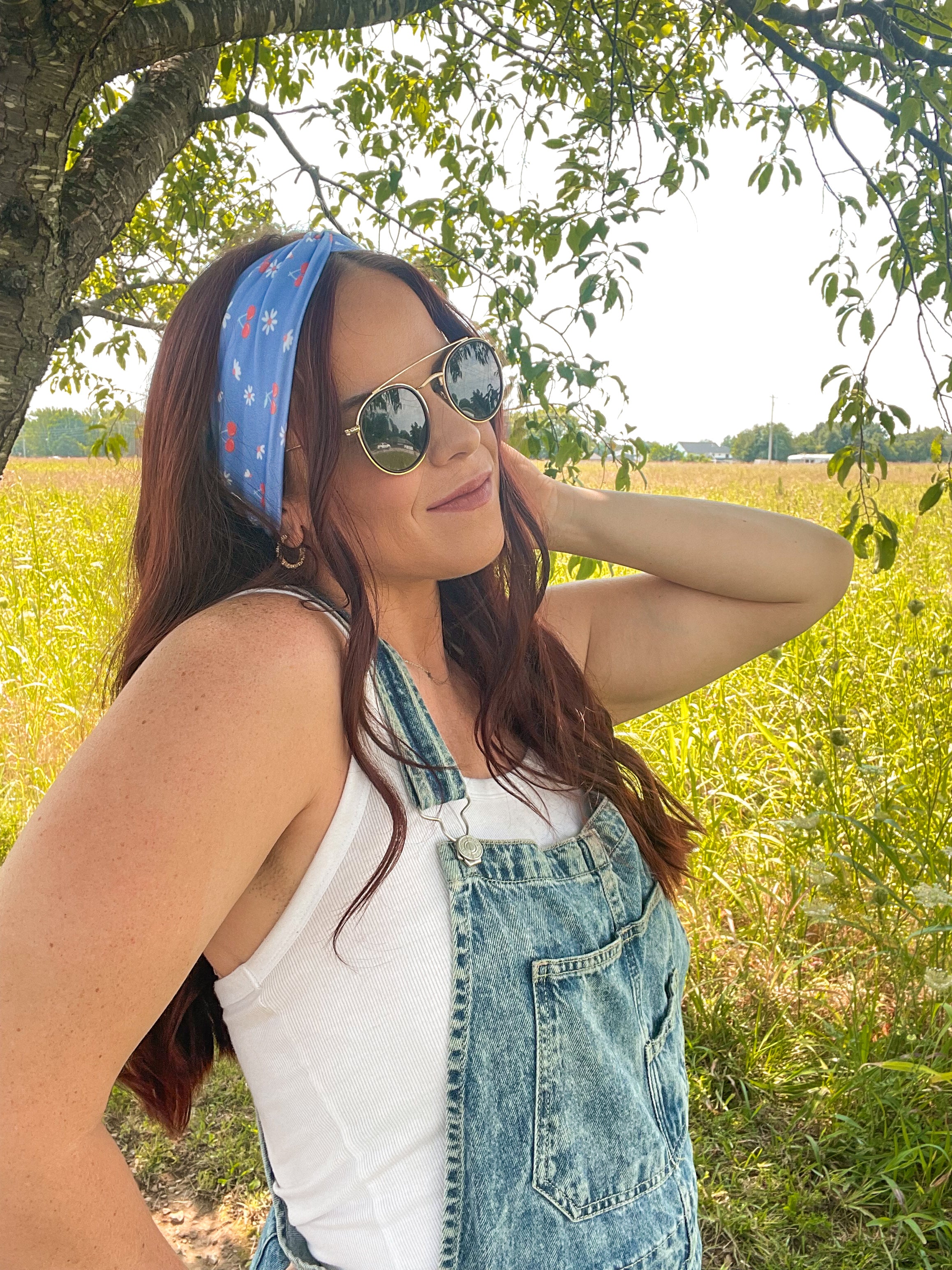 Woman in sunglasses confidently wearing the Cherry on Top headband, designed for comfort, versatility, and functionality.