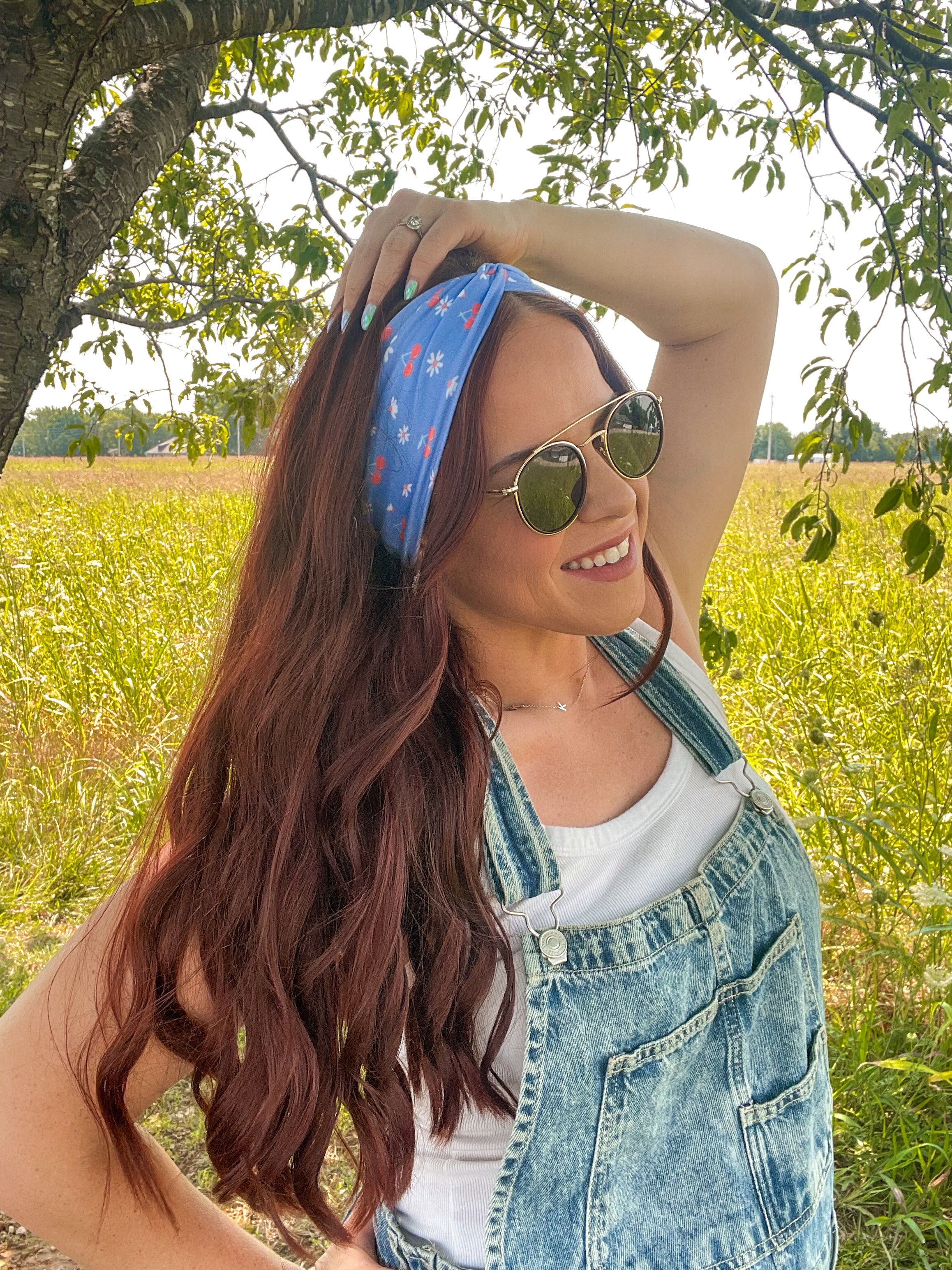 Woman in sunglasses confidently wearing the Cherry on Top headband, designed for comfort, versatility, and functionality.