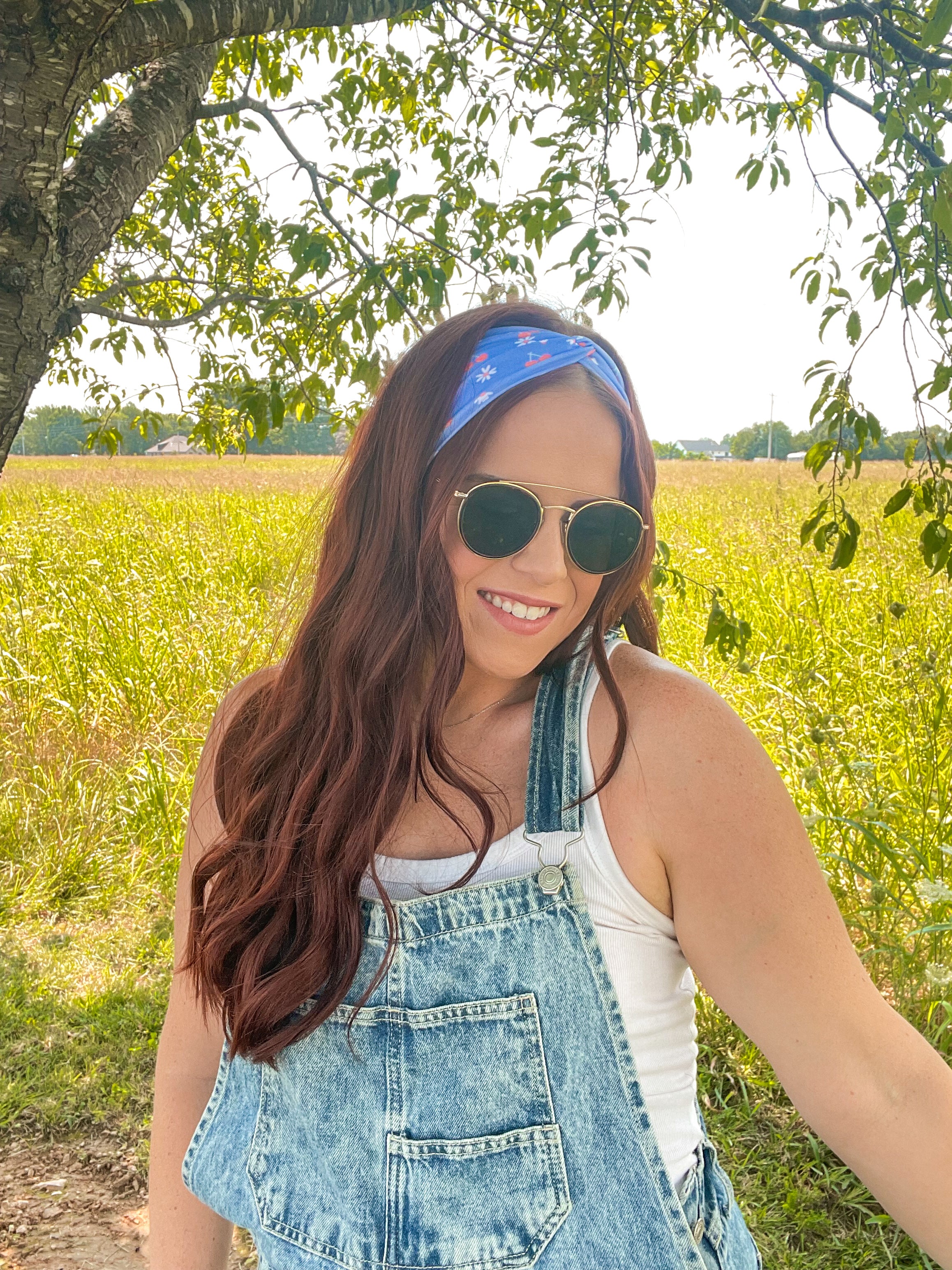 Woman in sunglasses confidently wearing the Cherry on Top headband, designed for comfort, versatility, and functionality.