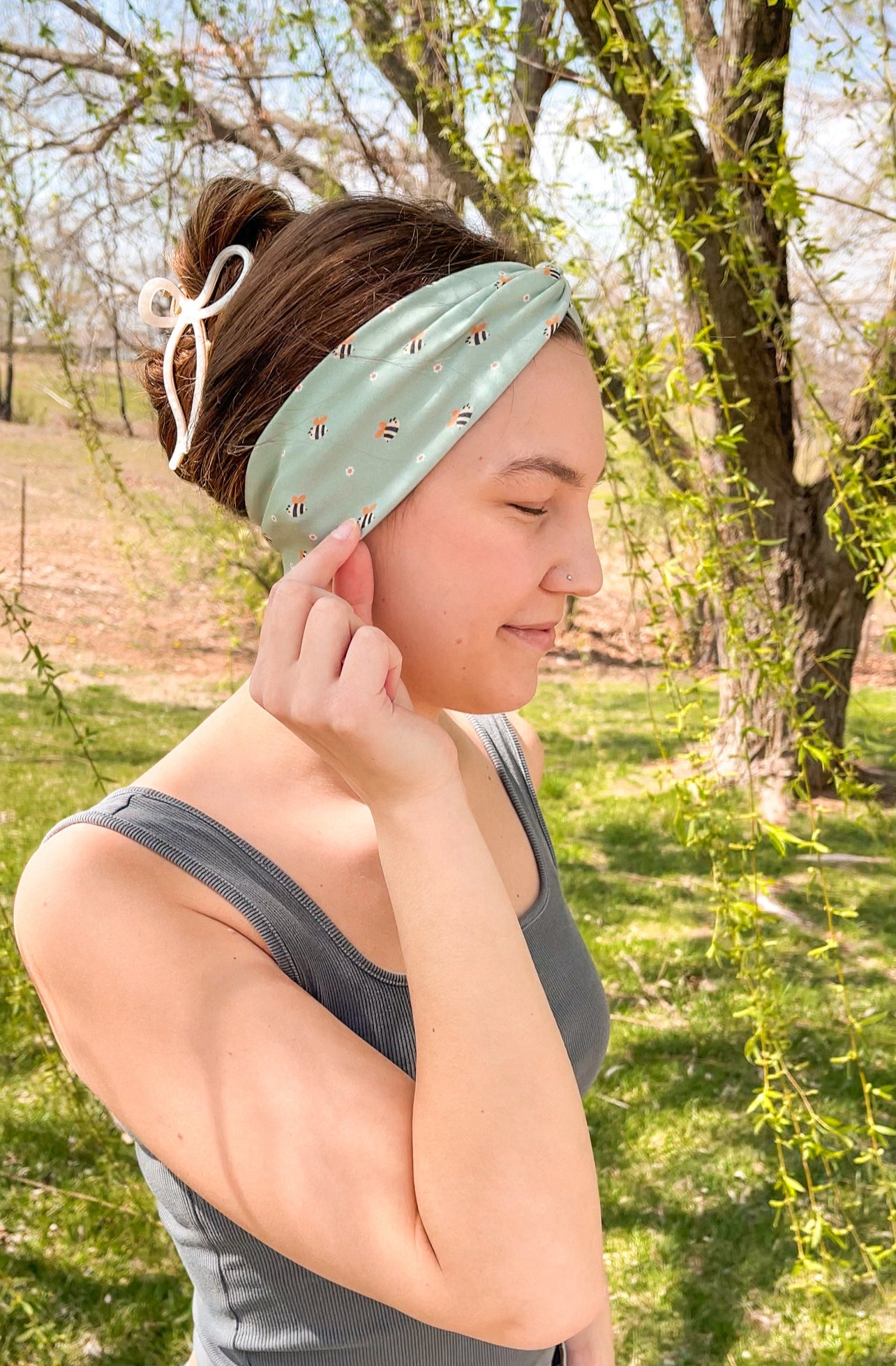 Woman confidently wearing the Cute As Can Bee headband for easy hairstyles and comfortable wear.