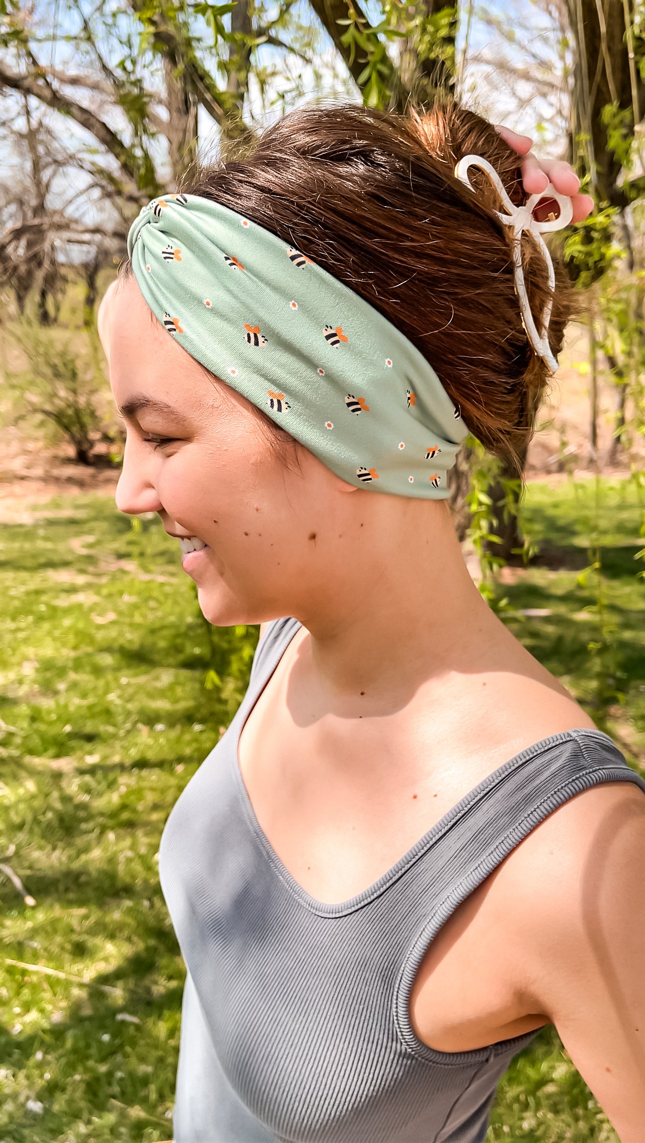 Woman confidently wearing the Cute As Can Bee headband for easy hairstyles and comfortable wear.