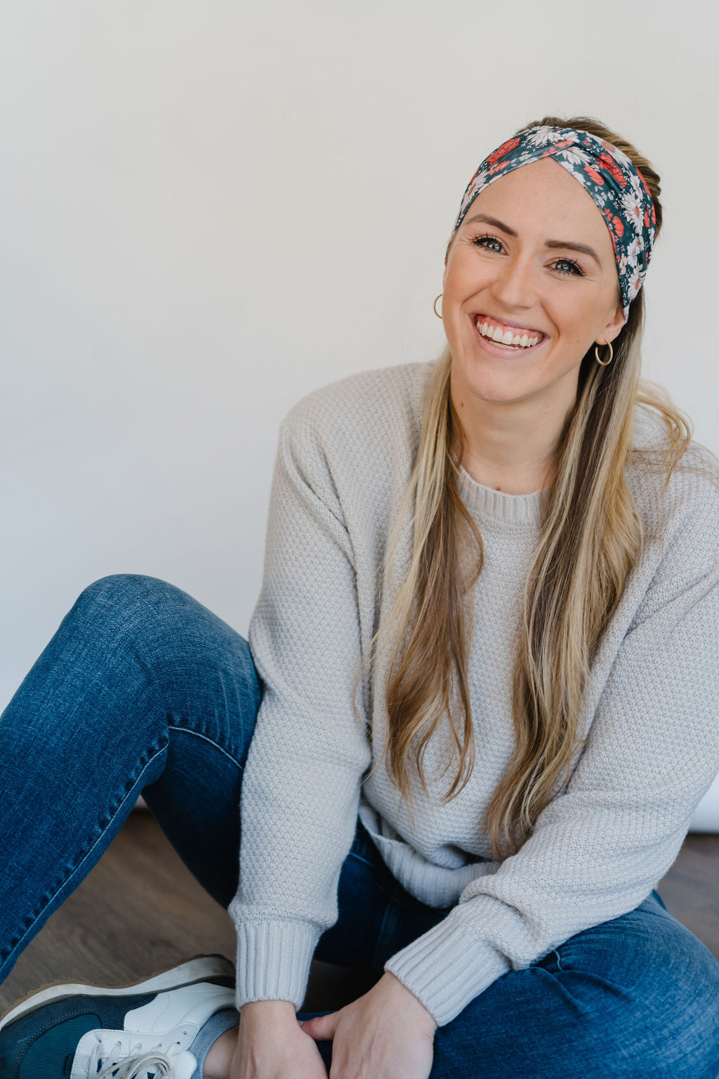 Adult women's dark forest green headband with red, white, and beige Christmas flowers