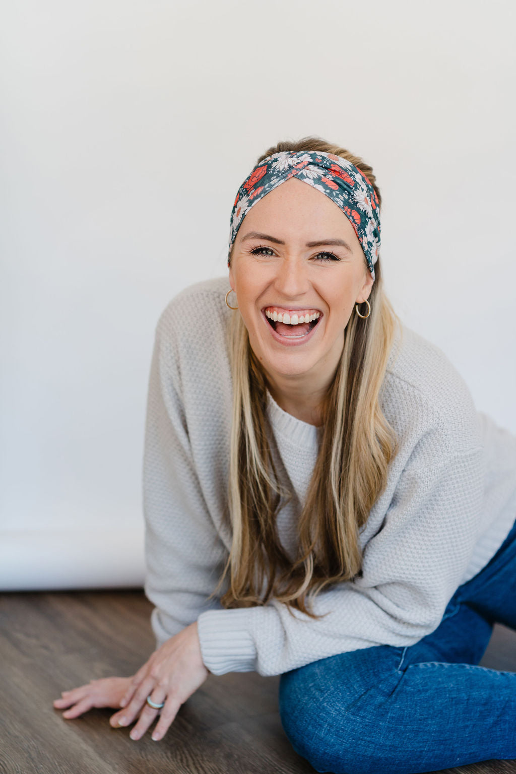 Adult women's dark forest green headband with red, white, and beige Christmas flowers
