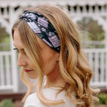A woman with blonde hair wearing a Uniquely Magic headband, showcasing a versatile 3-in-1 twist style. Functional, machine washable, sweat absorbent, and non-slip for workouts, shifts, or play.